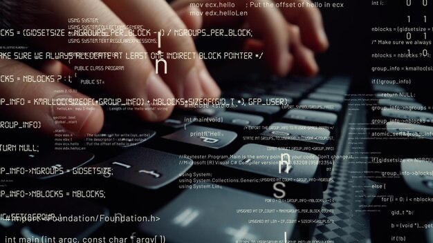 Fingers typing on the keyboard, program code in the foreground