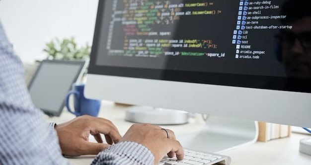 Man writes code on a computer